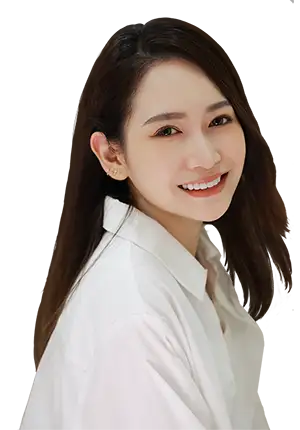 A girl wearing a yellow long-sleeved shirt and smiling.